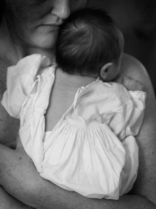 Mother hugging baby